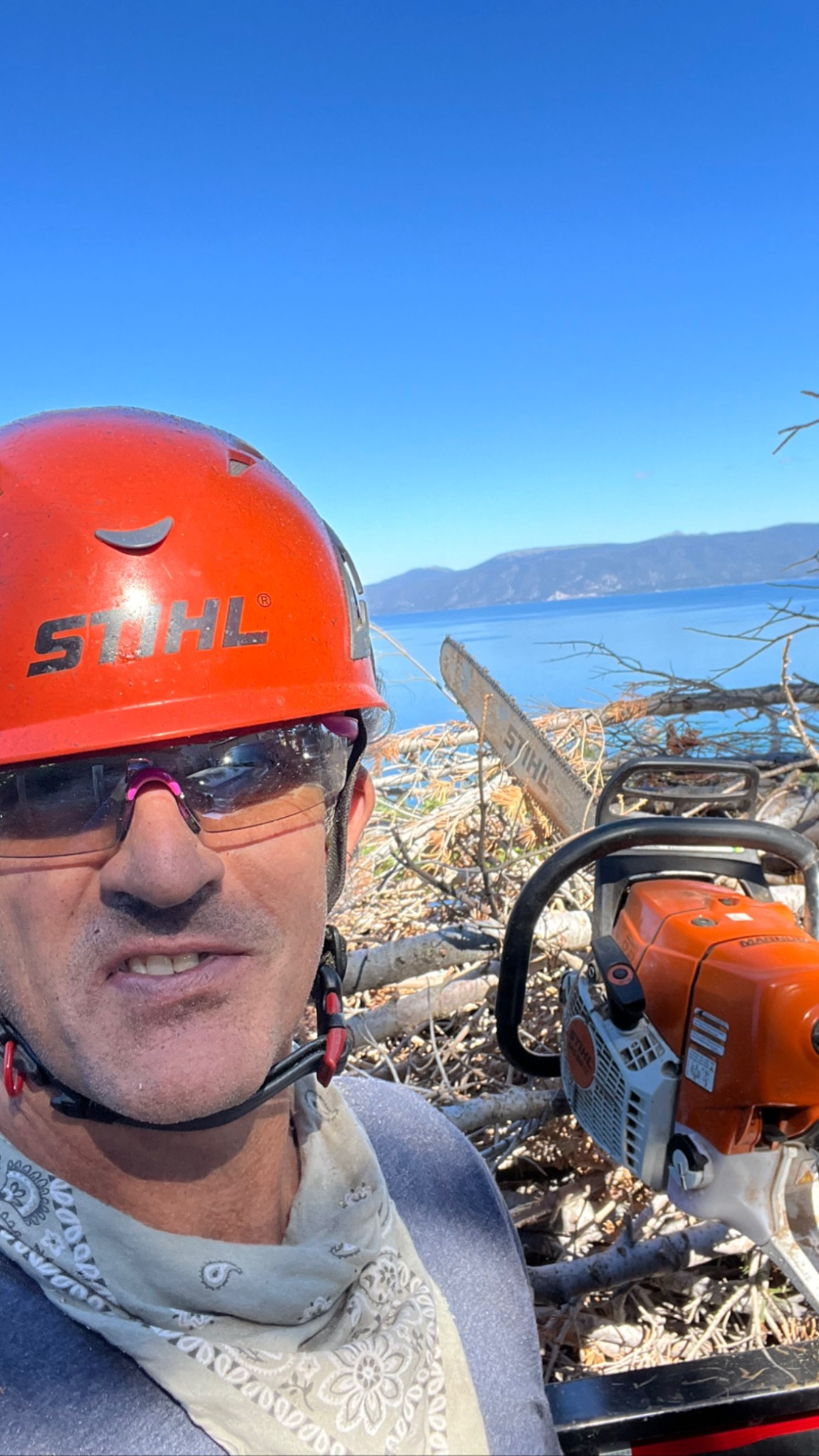 Billy Haupert with tree-work equipment above Lake Tahoe